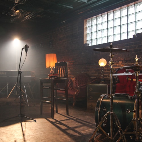Drums and microphones in a sunlit recording room